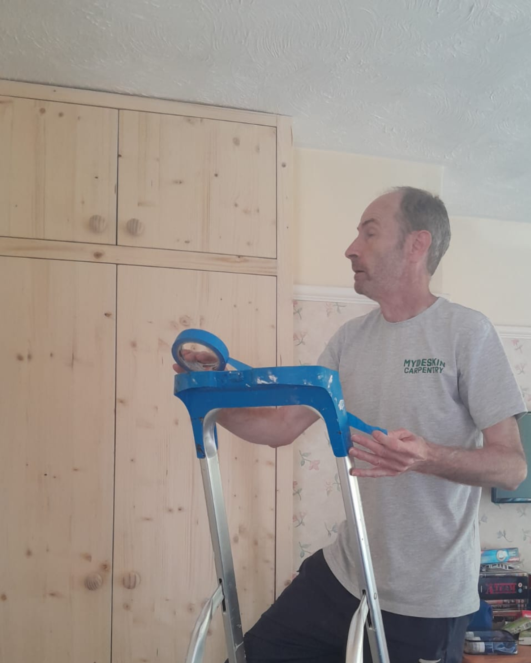 David Faulkner of MyDeskin Carpentry fitting a bespoke pine wardrobe